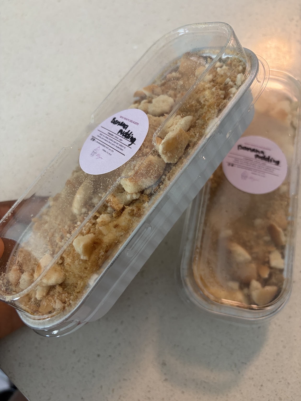 Moo Moo’s Delights banana pudding in labeled personal pans