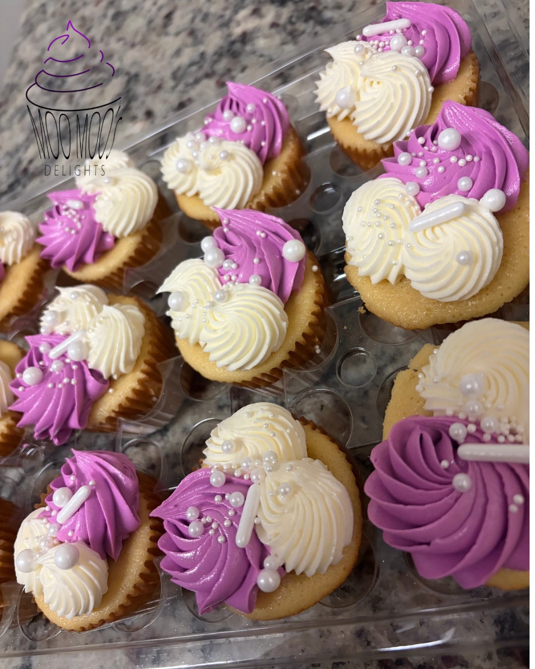 Purple and white frosted cupcakes with pearl sprinkles